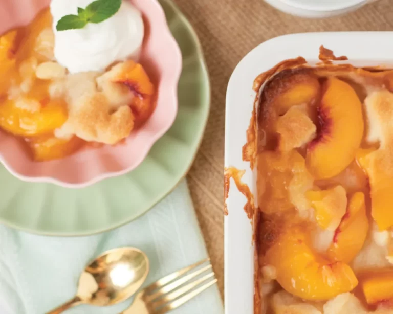 Delicious Southern Peach Cobbler served warm with ice cream on the side.