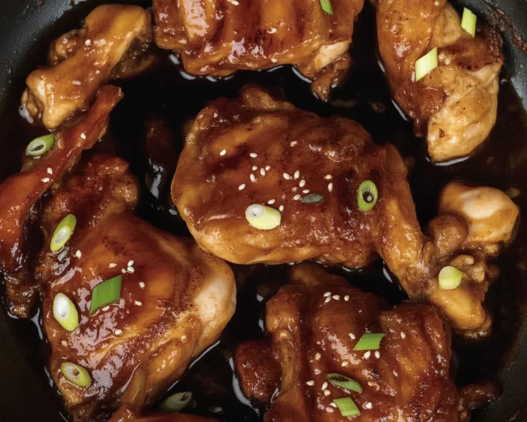 Sticky Honey Chicken served with coconut rice and garnished with sesame seeds.