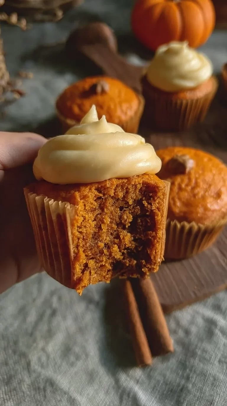 Delicious pumpkin cupcakes topped with cream cheese frosting and spices