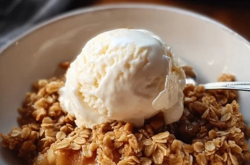Delicious Slow Cooker Apple Crisp topped with oats and served warm
